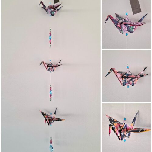 origami crane strung together with various beads to create a hanging mobile or suncatcher